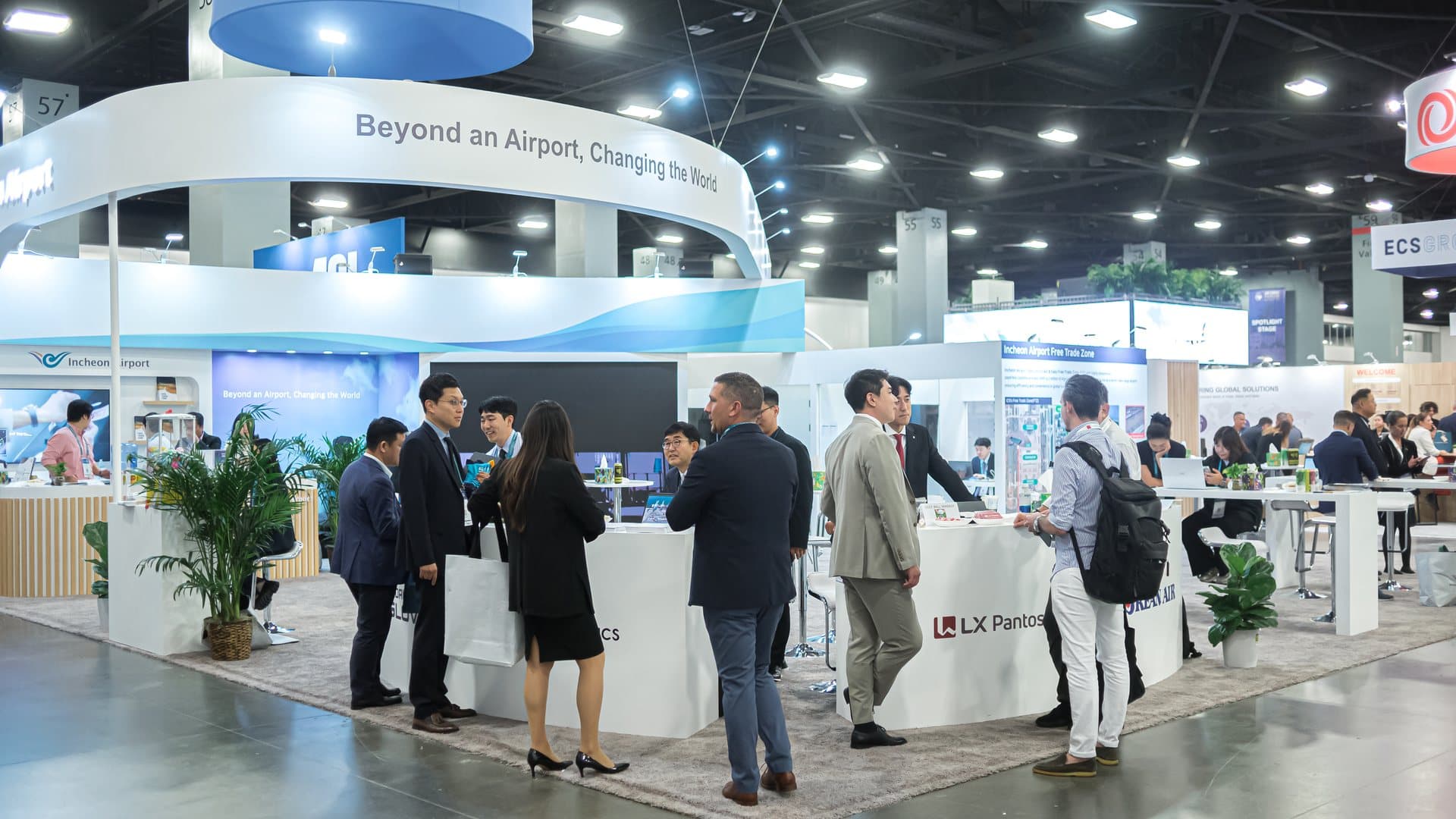 The Air Cargo Forum exhibition floor in Miami, with exhibitor stands across the hall
