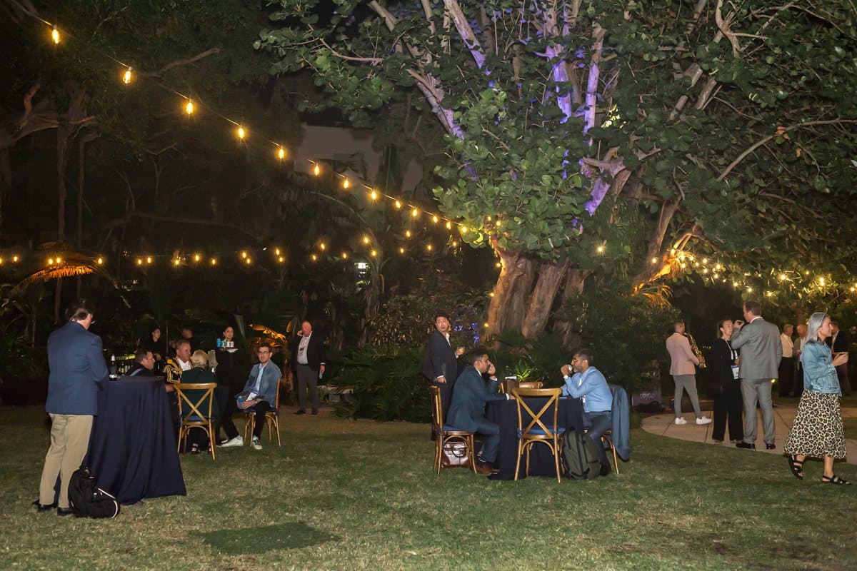 String lights above an outdoor evening reception at the Air Cargo Forum
