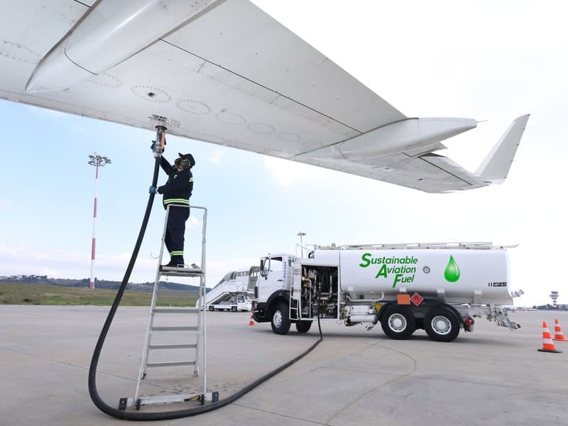 An aircraft being refuelled with sustainable aviation fuel