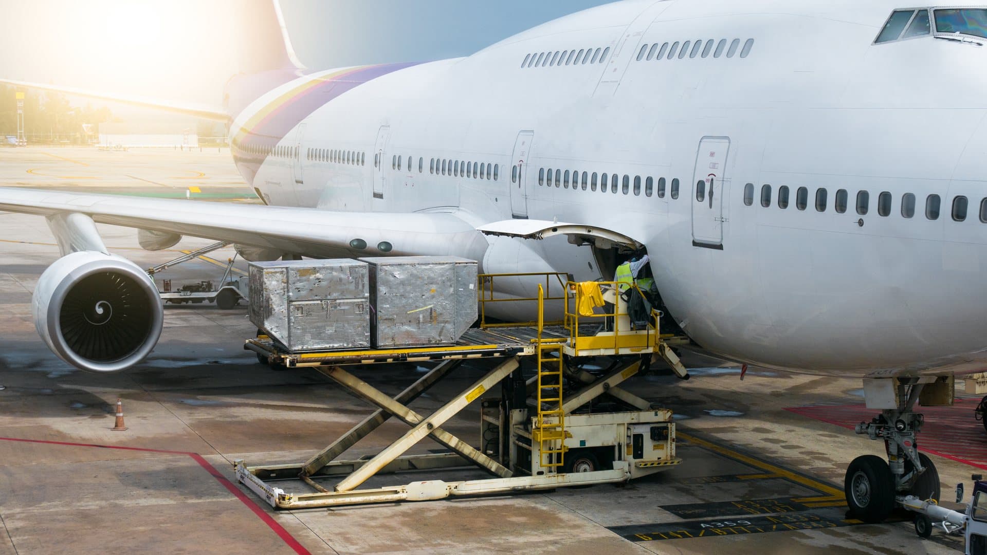 Ground crew loading cargo into a freighter aircraft through the side cargo door