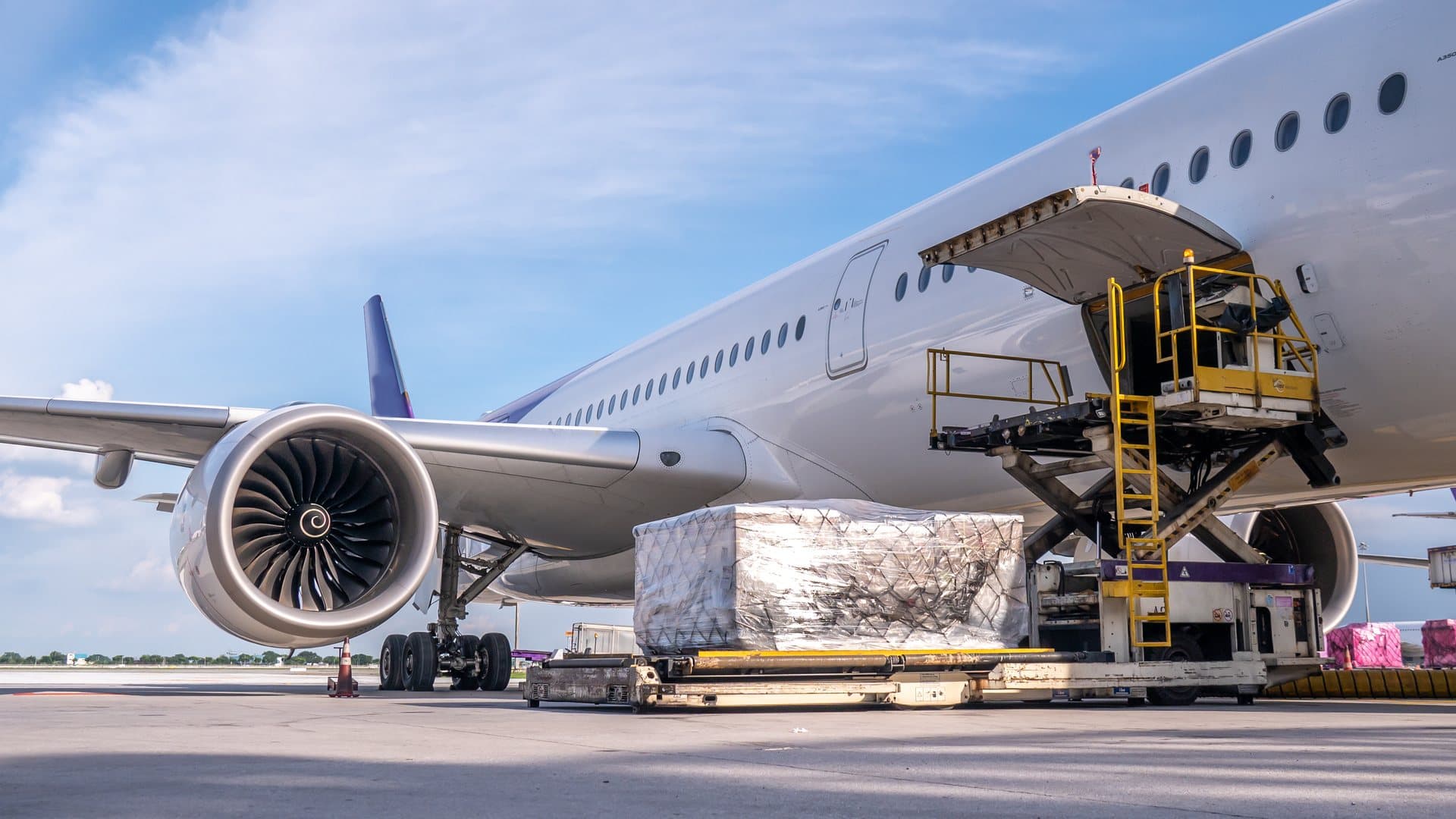 A cargo pallet being loaded into a widebody freighter aircraft